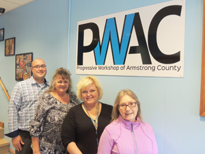 Progressive Workshop CEO Michelle Reefer (in black) and (back to front) Vice President of Production and Sales Matt Ardeno, Vice President of Programs and Compliance Kim Savoie and Vice President of Administration Karen Waugaman are preparing to open the doors to a new learning opportunity in a few months.