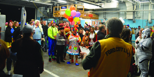 Ford City Halloween Parade marchers wait to hear if they received a top prize as part of last year's event. More than 350 people attended last year and about the same amount are expected Thursday evening.