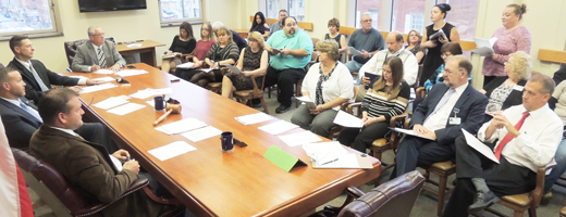 SEIU Representatives for Armstrong County Health Center employees Sharon Pope and Kristy Myers (right) talk with Armstrong County Commissioners yesterday morning after bids were opened for the possible sale of the Kittanning facility.