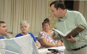 Ford City Borough Council Vice-President Tyson Klukan peeks from behind a local map to talk with PennEnergy Resources Land Manager Zach Dixon about the company's proposal to lease up to five acres of Ford City property along the Allegheny River.