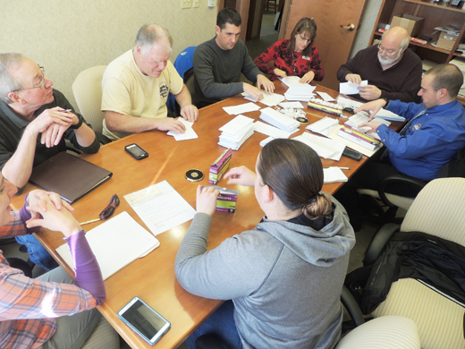 Ford City Borough Planning Commission Member Tim Wakefield talks to board of directors of the new Ford City Area Business and Professional Association Wednesday while they stuff envelopes with membership applications.