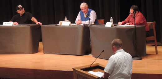 Incumbent Senator Don White (on stage, center) responds to a question posed by West Shamokin High School students during a debate last night featuring Senator White and his two opponents - Democrat Tony DeLoreto and Independent Stanley Buggey.