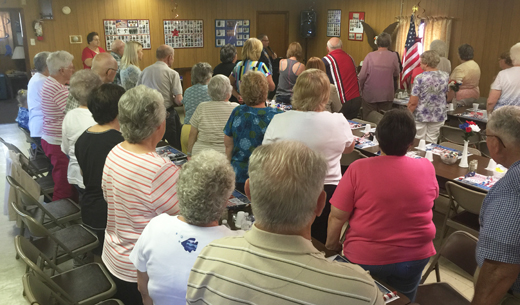 Nearly 100 senior citizens filled the Armstrong County Area Agency on Aging Dayton Senior Center for a special program last Thursday. They stand as they pledge allegiance to the American flag.