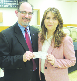 After 25 community residents donated and became members of a new RAID chapter in Parker City last night, Armstrong County District Attorney Scott Andreassi presented a check of $250 matching funds to RAID chairwoman Kim Palmer.